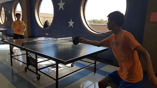 2 club members playing ping pong 